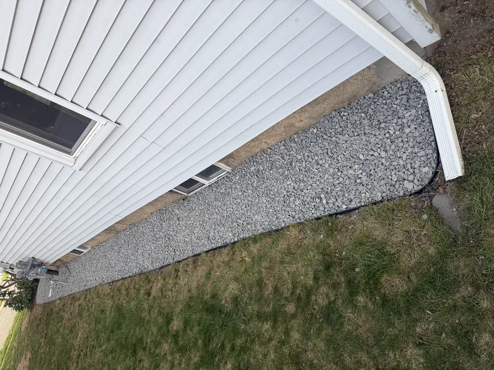 Gravel drainage bed installed along home foundation in Northborough MA