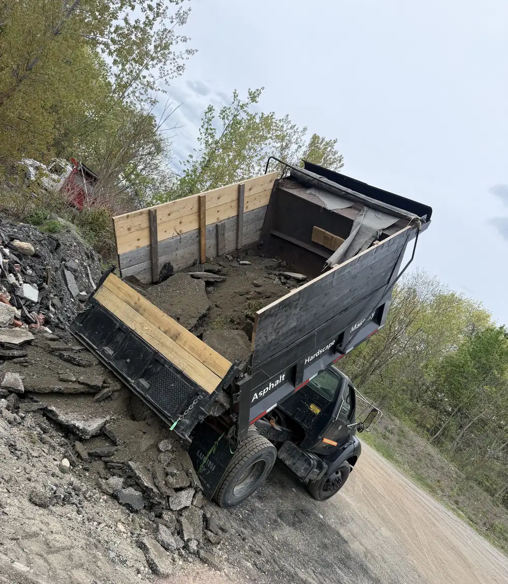 TB Lawn and Landscape dump truck on active excavation site